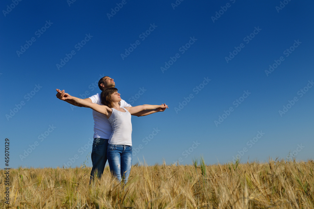 happy couple in wheat field