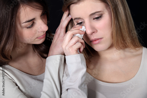 Girl comforting another girl
