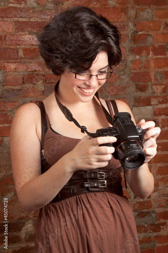 Portrait of a happy young girl in glasses smiling