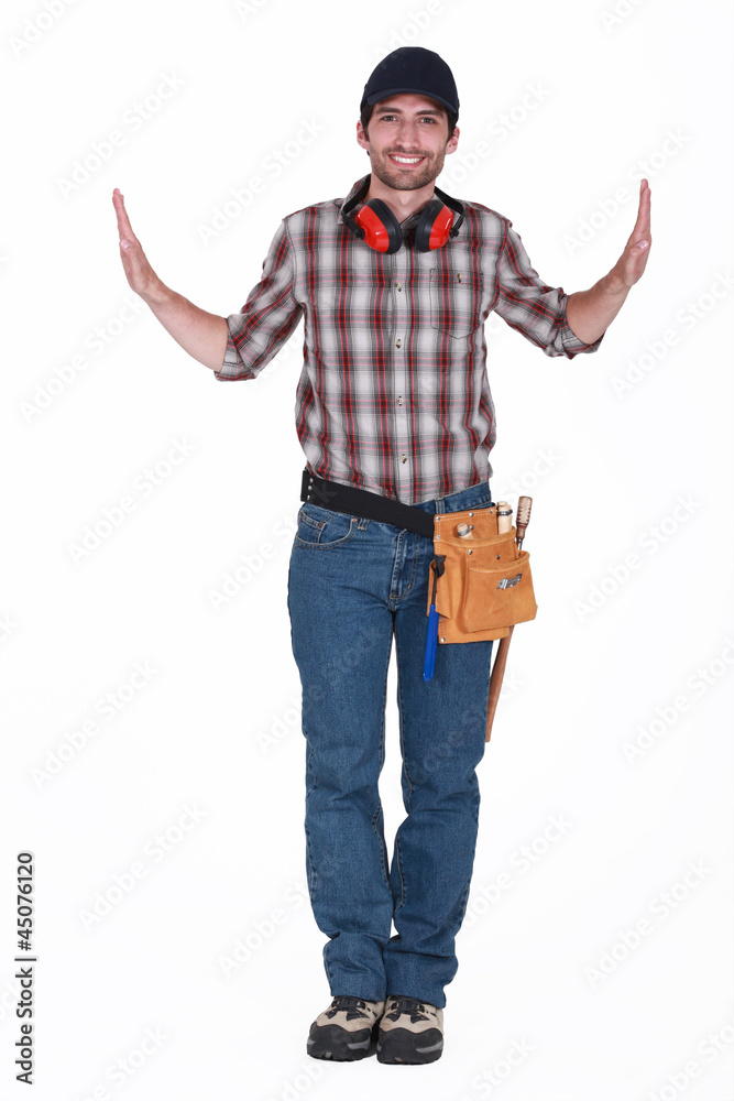handsome carpenter with hands raised on either side handsome carpenter with hands raised on either side