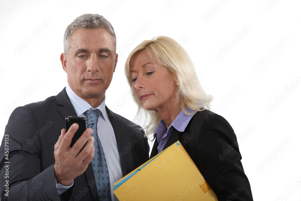 A team of business professionals reading a text message A team of business professionals reading a text message