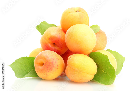 ripe apricots with green leaves isolated on white