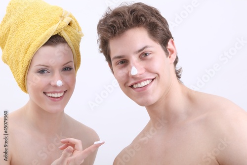 young woman and young man with lotion