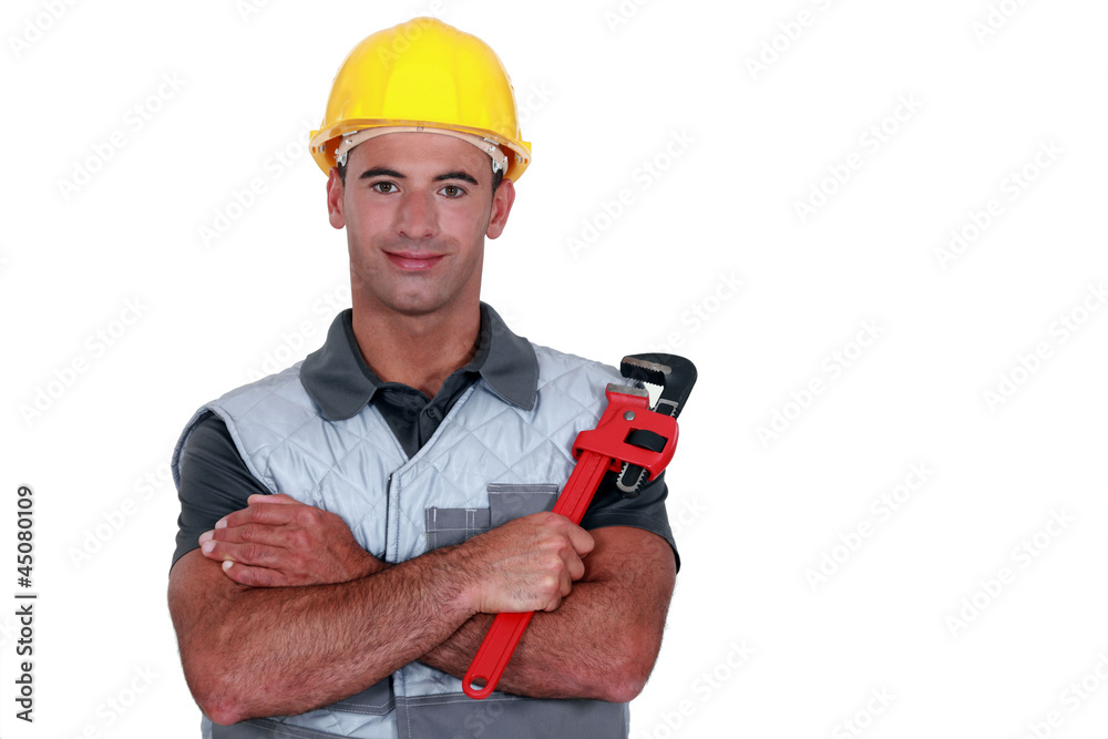 portrait of tradesman cross-armed holding adjustable spanner portrait of tradesman cross-armed holding adjustable spanner