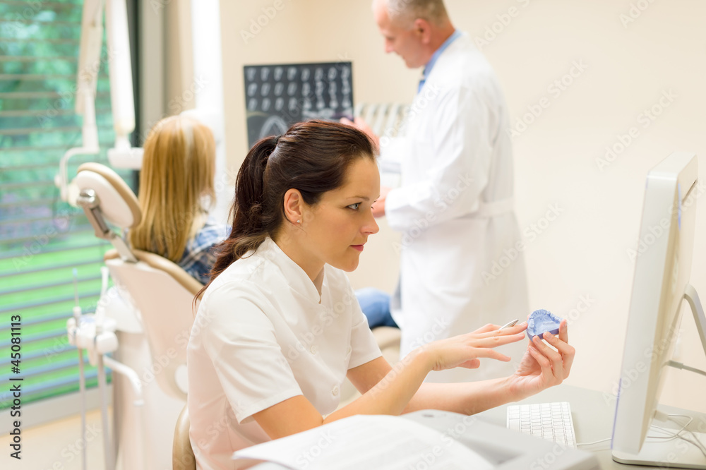 Fototapeta premium Dental surgery nurse hold print of teeth