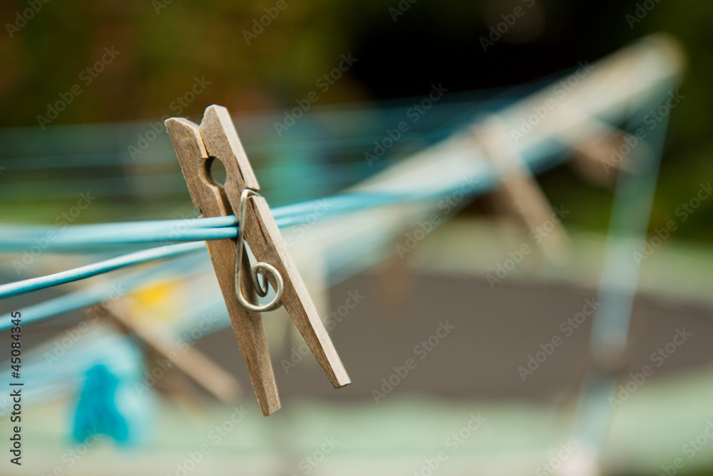 Wooden clothes peg on a washing line