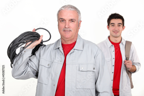 Bilde på lerret An experienced tradesman posing with his new apprentice