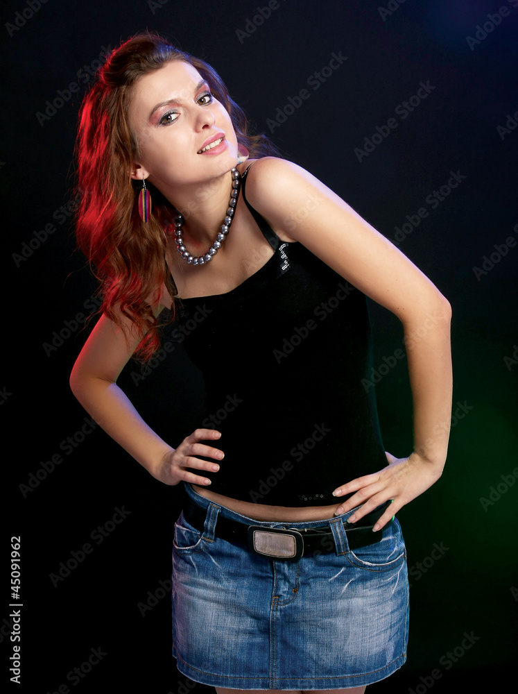 A young stylish girl, isolated on black background