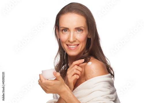 Woman applying moisturizing cream