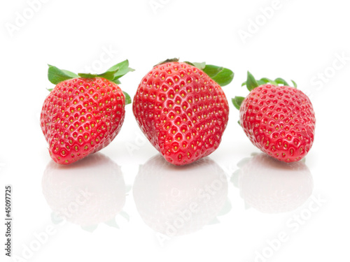 three strawberries on a white background close-up