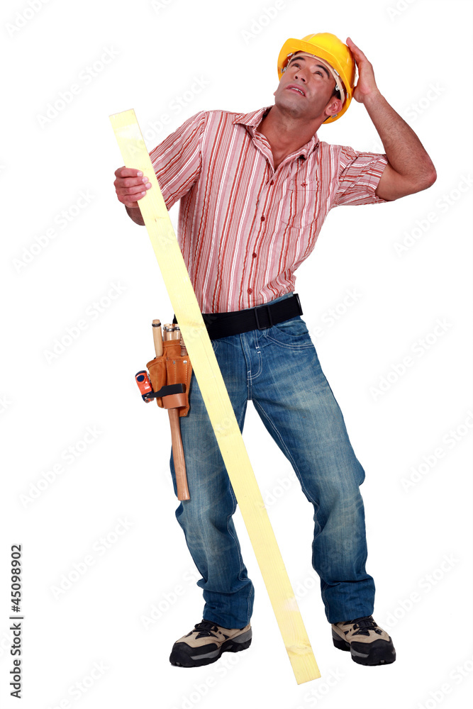 Tradesman trying to protect himself from falling debris Tradesman trying to protect himself from falling debris