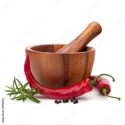 fresh flavoring herbs and spices in wooden mortar