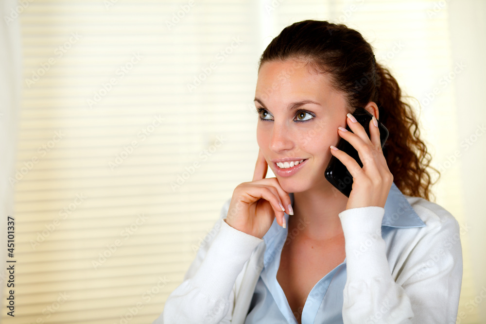Smiling caucasian woman conversing on cellphone Smiling caucasian woman conversing on cellphone