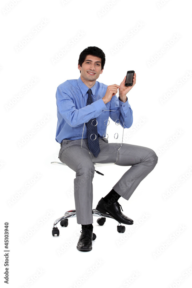 Businessman holding up his mobile phone Businessman holding up his mobile phone