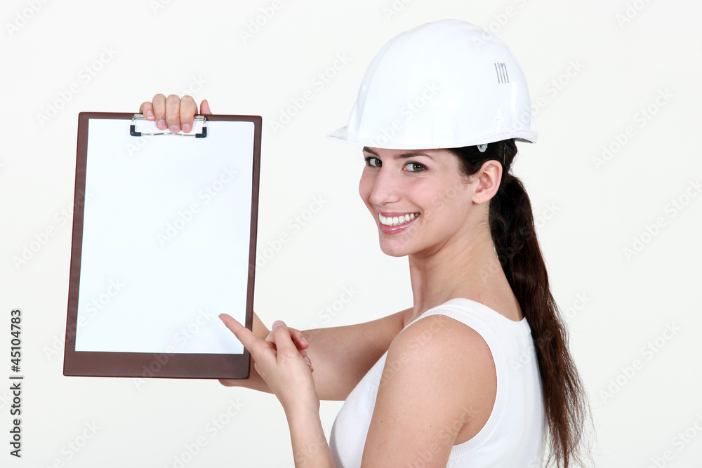 cute female apprentice pointing at clipboard cute female apprentice pointing at clipboard