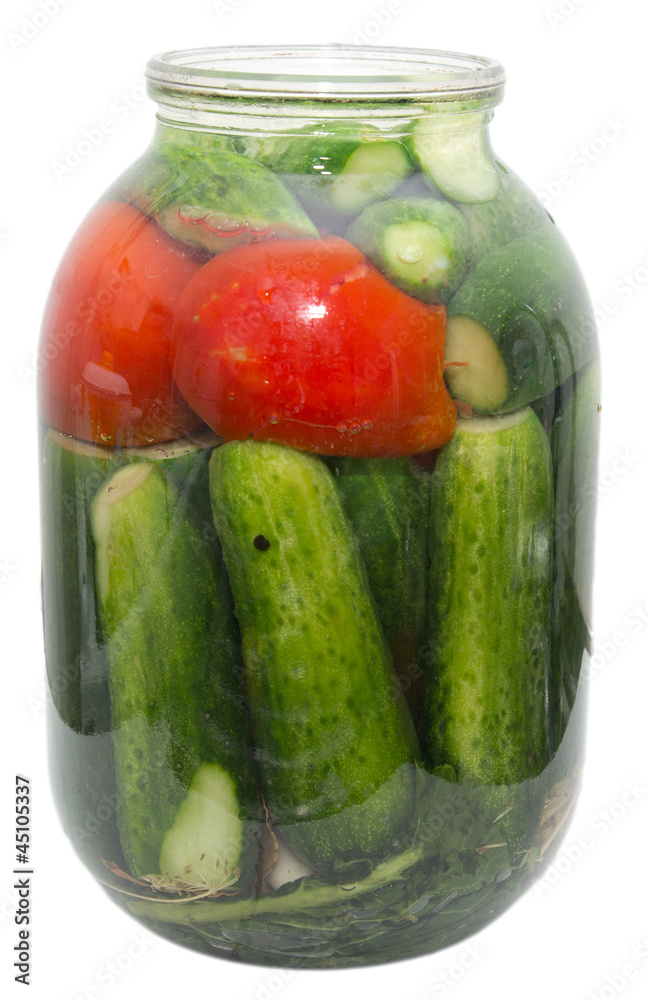 salted cucumber and tomatoes in a jar on a white background salted cucumber and tomatoes in a jar on a white background