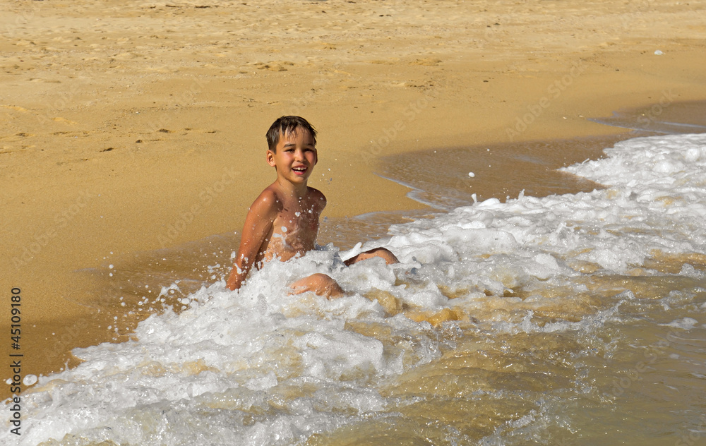 Boy playing in the waves