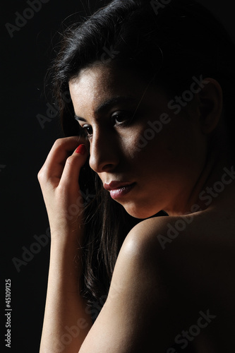 Lonely woman isolated black background