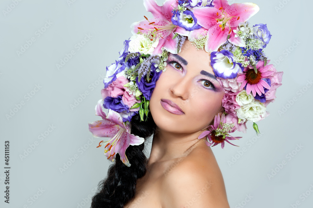 Portrait of beautiful girl with stylish makeup and violet flower