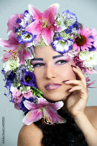 Fototapeta Naklejka Na Ścianę i Meble -  Portrait of beautiful girl with stylish makeup and violet flower