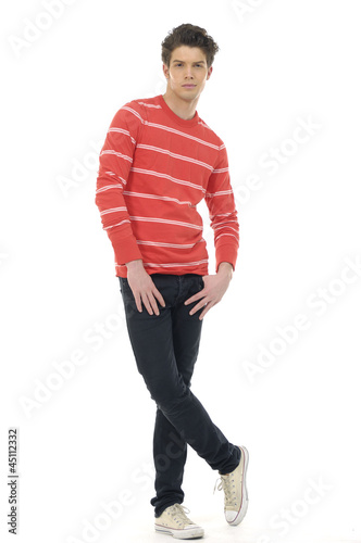 Young casual man standing with hands in pockets