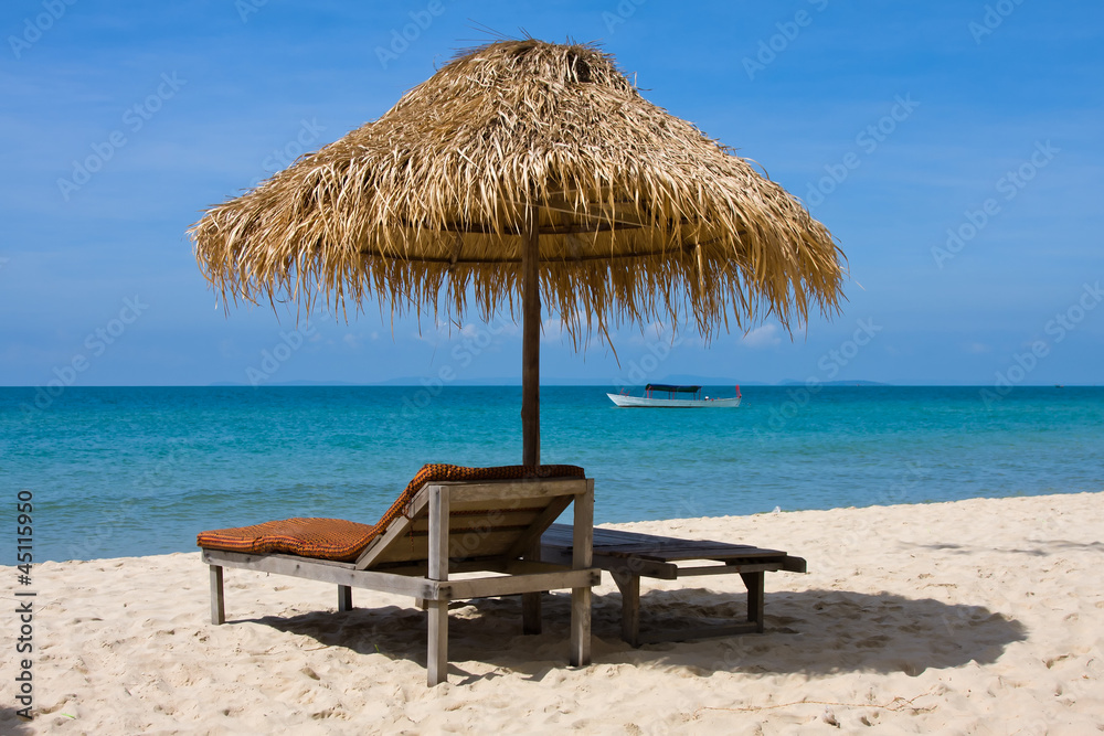 Sun loungers with umbrella on the beach