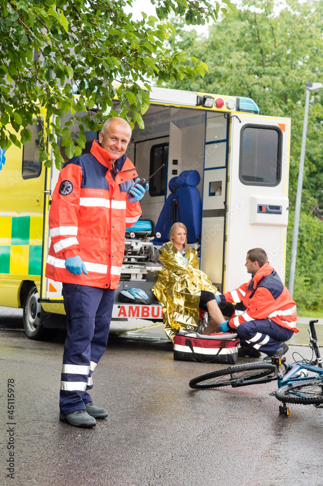 Paramedics helping woman bike accident ambulance Stock Photo | Adobe Stock