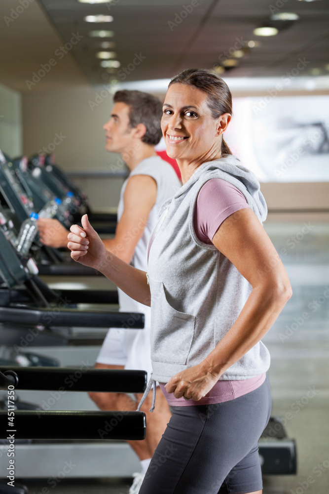 Woman And Man Running On Treadmill Woman And Man Running On Treadmill