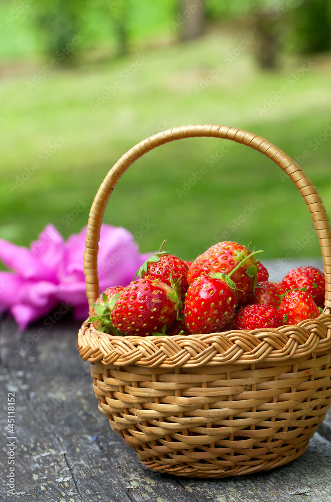 strawberries in basket on wooden table strawberries in basket on wooden table