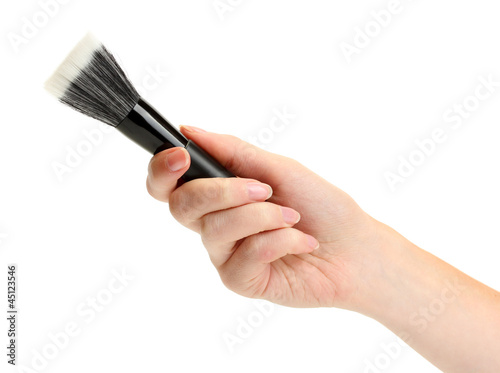 hand with black brush for make-up isolated on white.