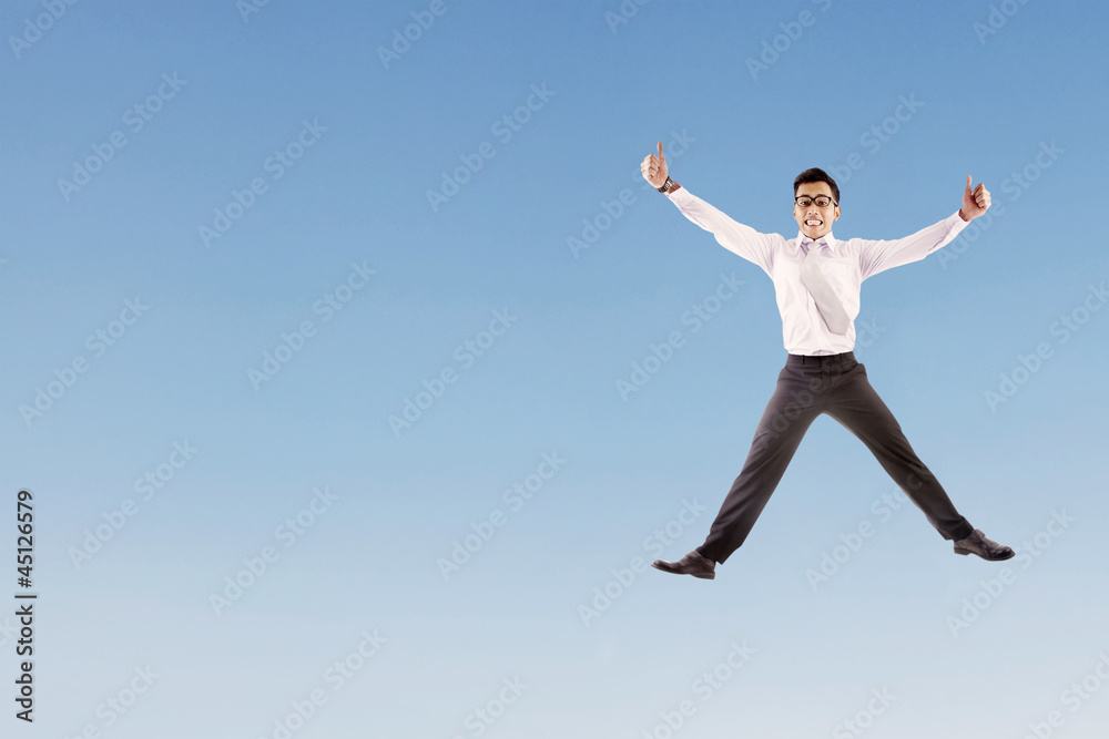 Happy businessman jumping