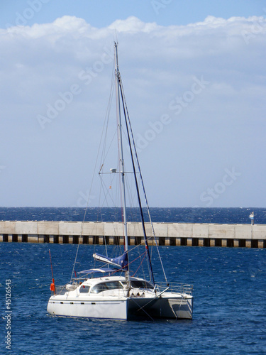 Catamaran anchored near jetty, Spain