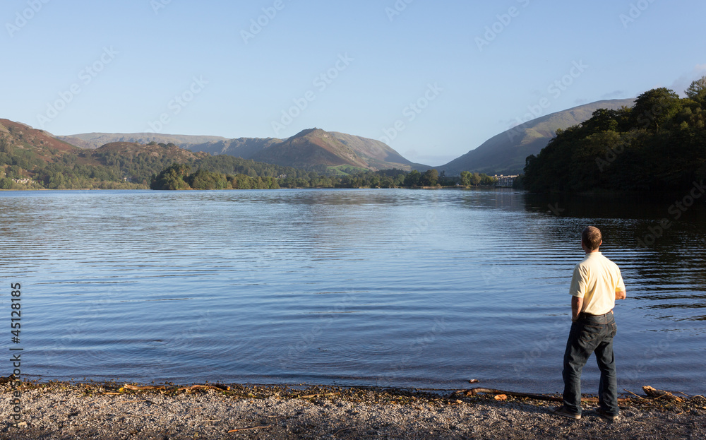 Hiker at Grasmere at dawn in Lake District Hiker at Grasmere at dawn in Lake District