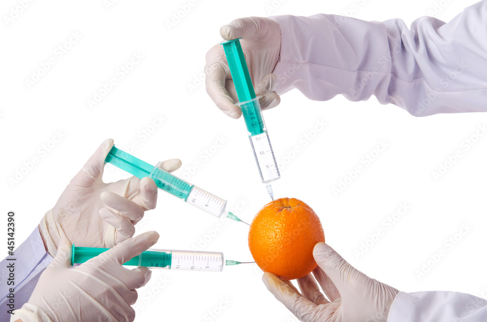 Science experiment with orange and syringe Science experiment with orange and syringe