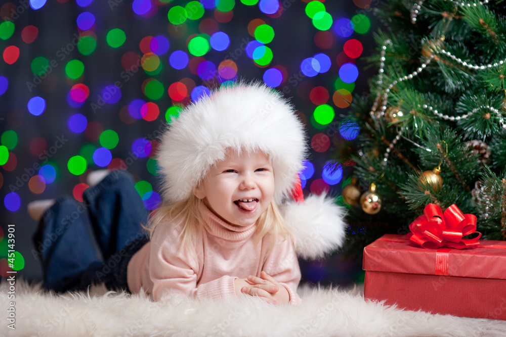 funny baby in Santa Claus hat on bright festive background funny baby in Santa Claus hat on bright festive background