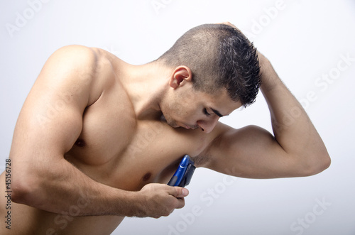 young man shaving the armpit,