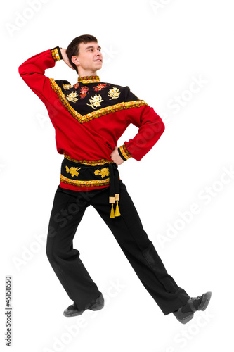 young dancer wearing a folk russian costume dancing