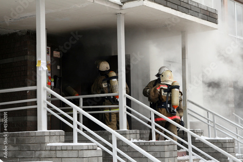 firefighters team at burning house