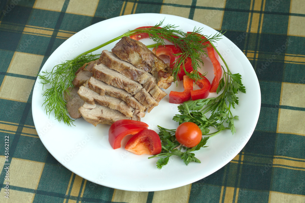 Plate with stew and vegetables on green plaid tablecloth Plate with stew and vegetables on green plaid tablecloth