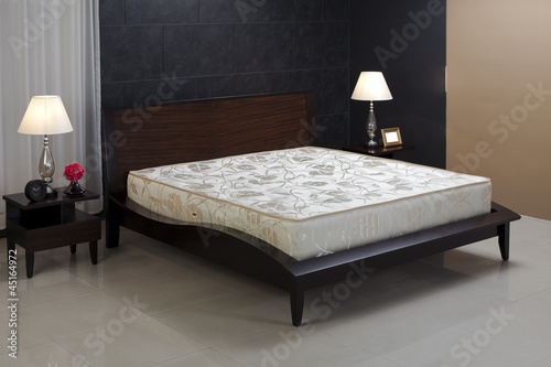 Nice and cozy spring mattress isolated in bedroom