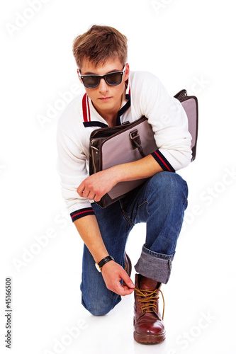 Portrait of sleazy young man posing on white background with bag photo