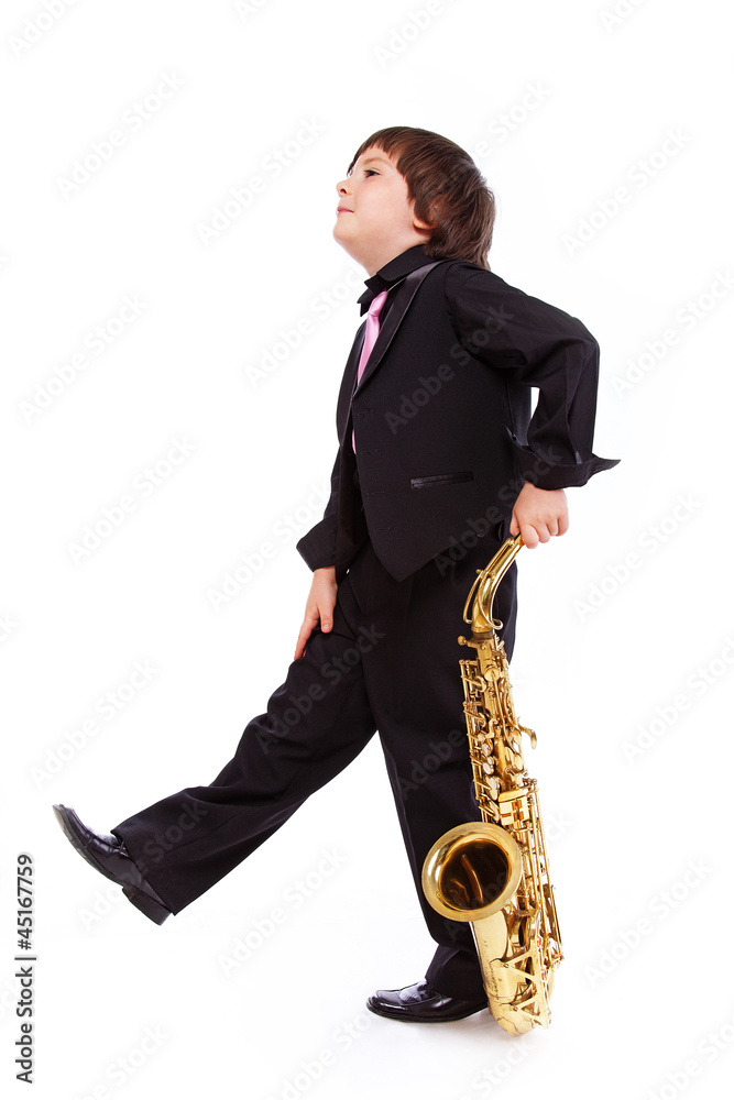 Naklejka premium Portrait of handsome kid posing in studio with saxophone