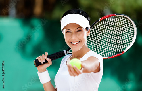 Woman in sportswear serves tennis ball. Tournament