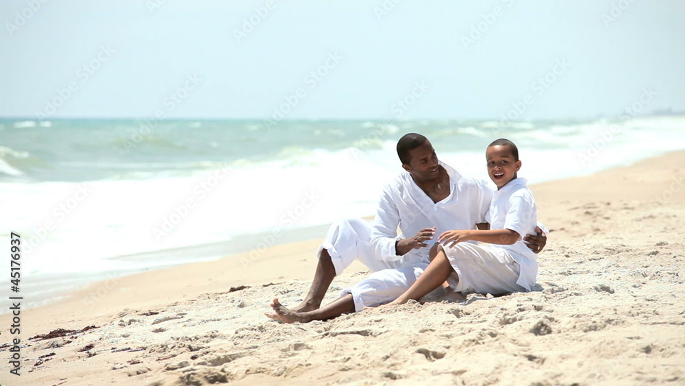 Ethnic parent son holiday time on summer beach Ethnic parent son holiday time on summer beach