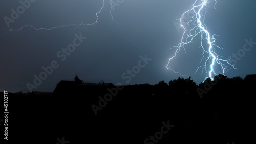 Thunder with flash above a village