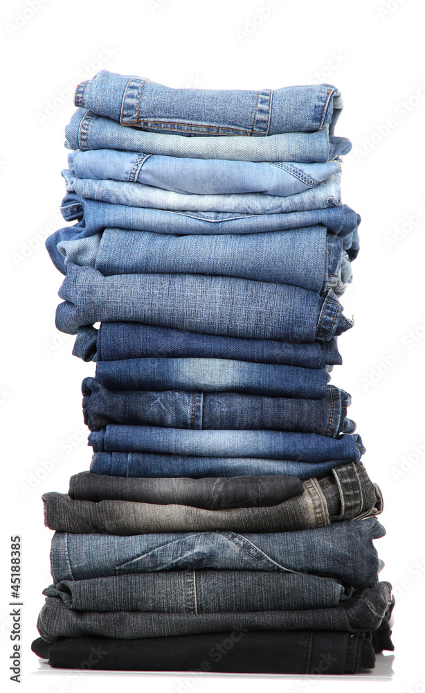 Many jeans stacked in a pile isolated on white Many jeans stacked in a pile isolated on white