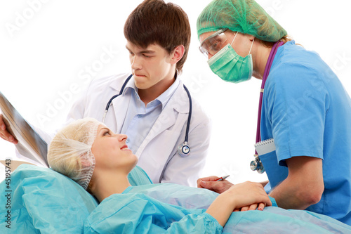 Male doctors talking to a female patient before