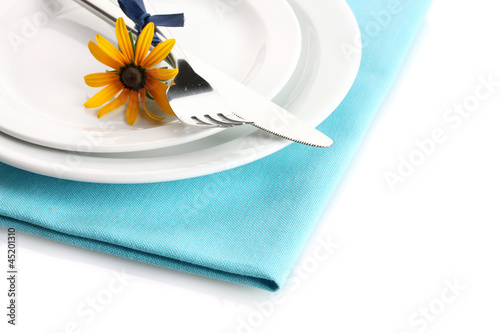 knife, fork and flower on plate, isolated on white