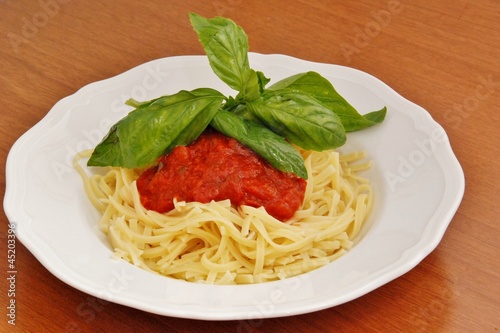 pasta spaghetti with tomato sauce and basil photo