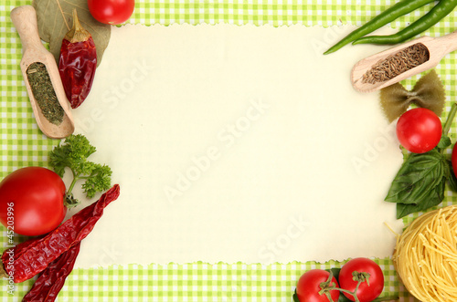 paper for recipes vegetables and spices on green background